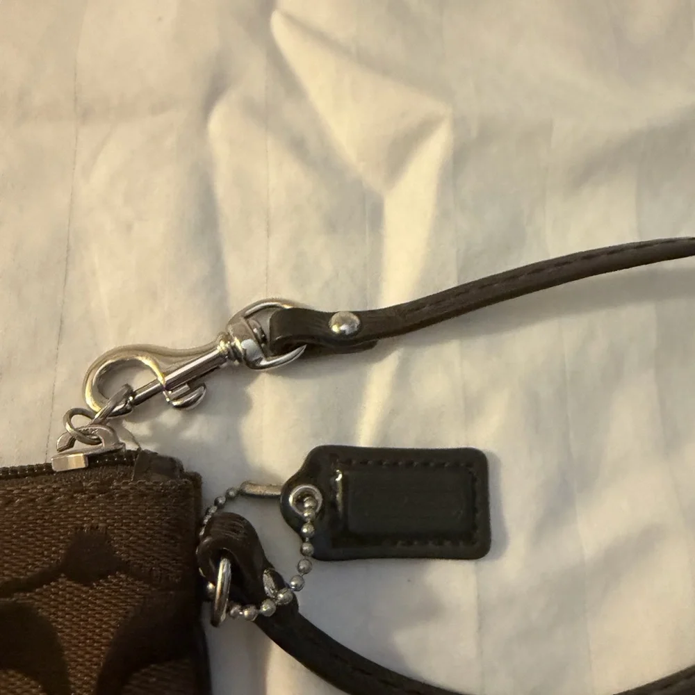 Coach Signature C canvas wristlet.